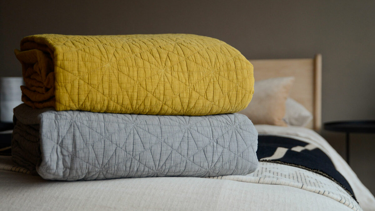 ochre and grey hexagon embroidered bedspreads stack