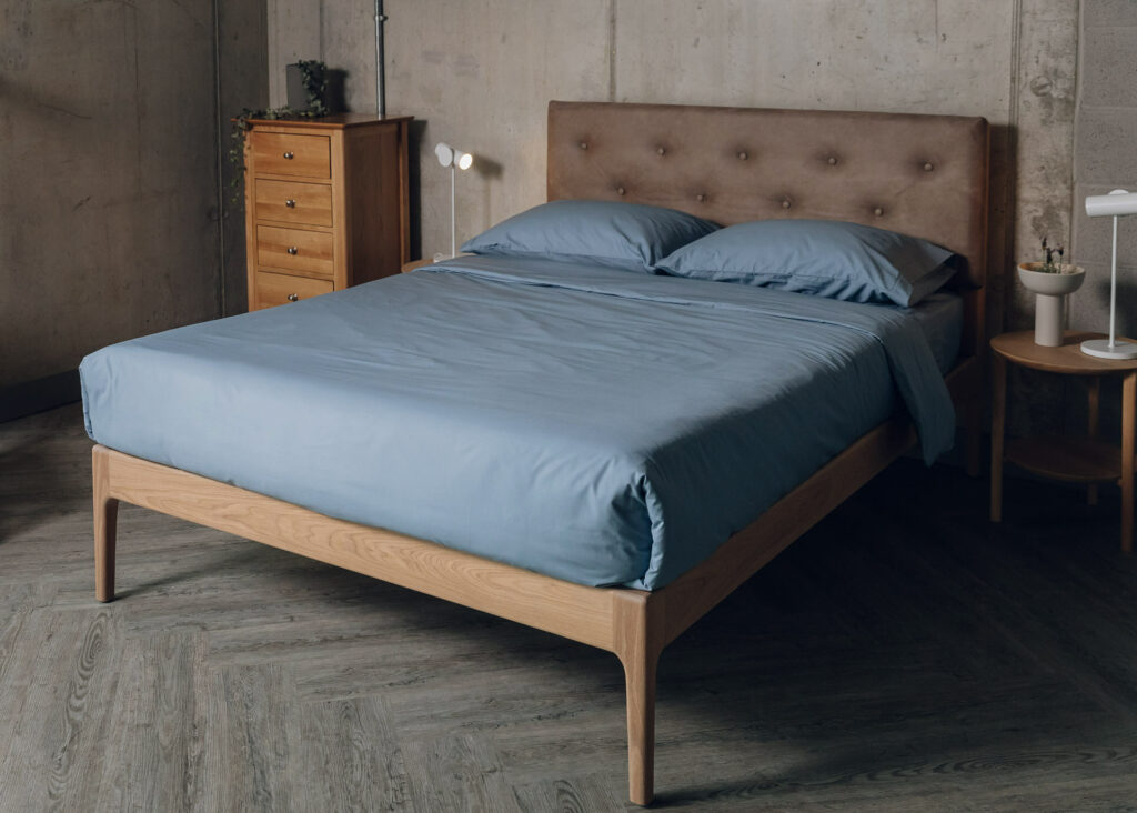 Oak Bloomsbury bed with oiled frame and a headboard upholstered in a faux leather