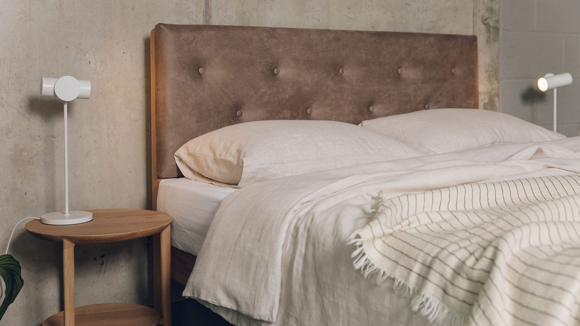 vegan freindly faux leather headboard of the Bloomsbury bed shown with linen bedding