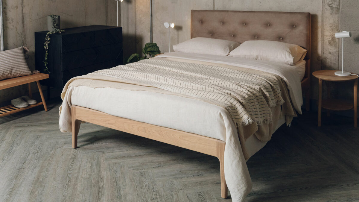 buttoned and upholstered Bloomsbury bed with an oiled oak wooden base