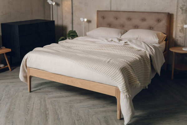 an oiled finish oak Bloomsbury bed with a buttoned faux leather headboard hand made in Yorkshire