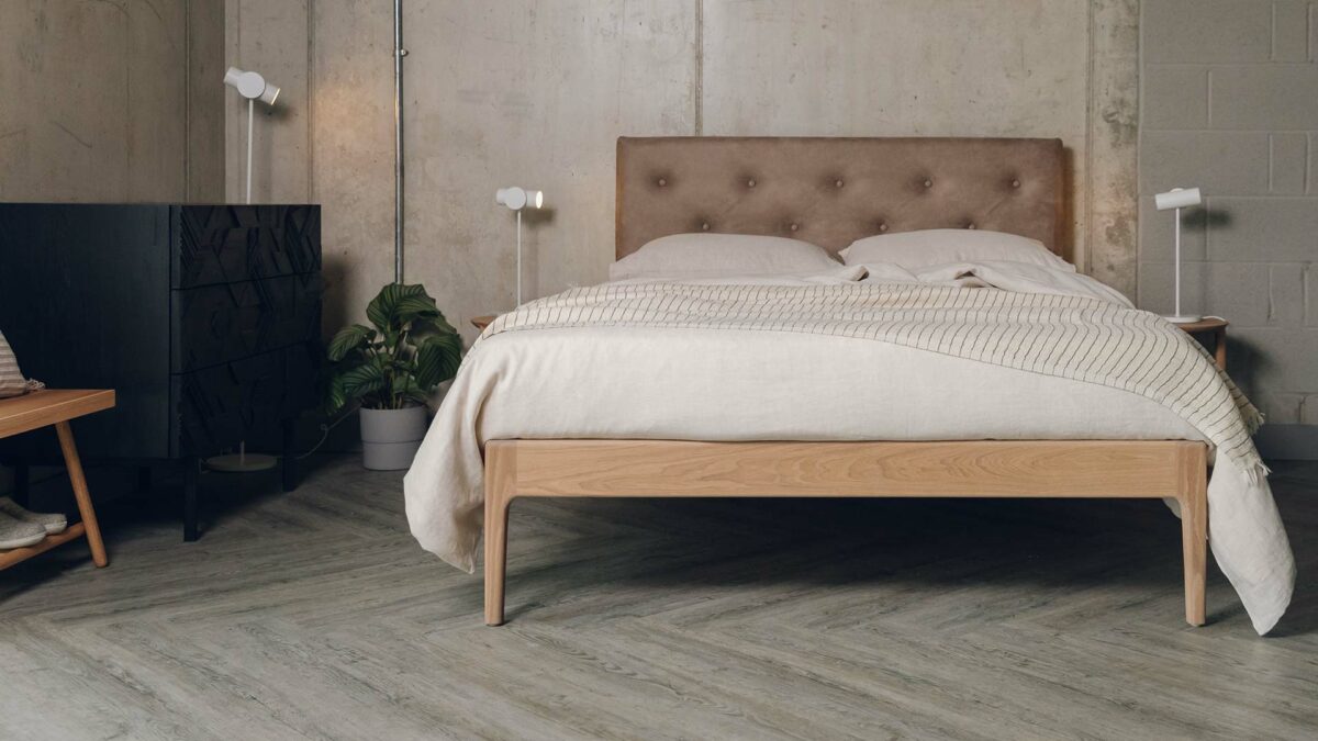 oiled oak finish Bloomsbury bed with faux leather headboard shown with linen bedding