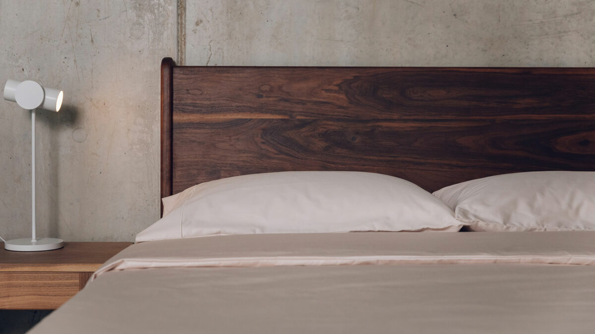 oiled walnut Camden bed headboard with shell bedding