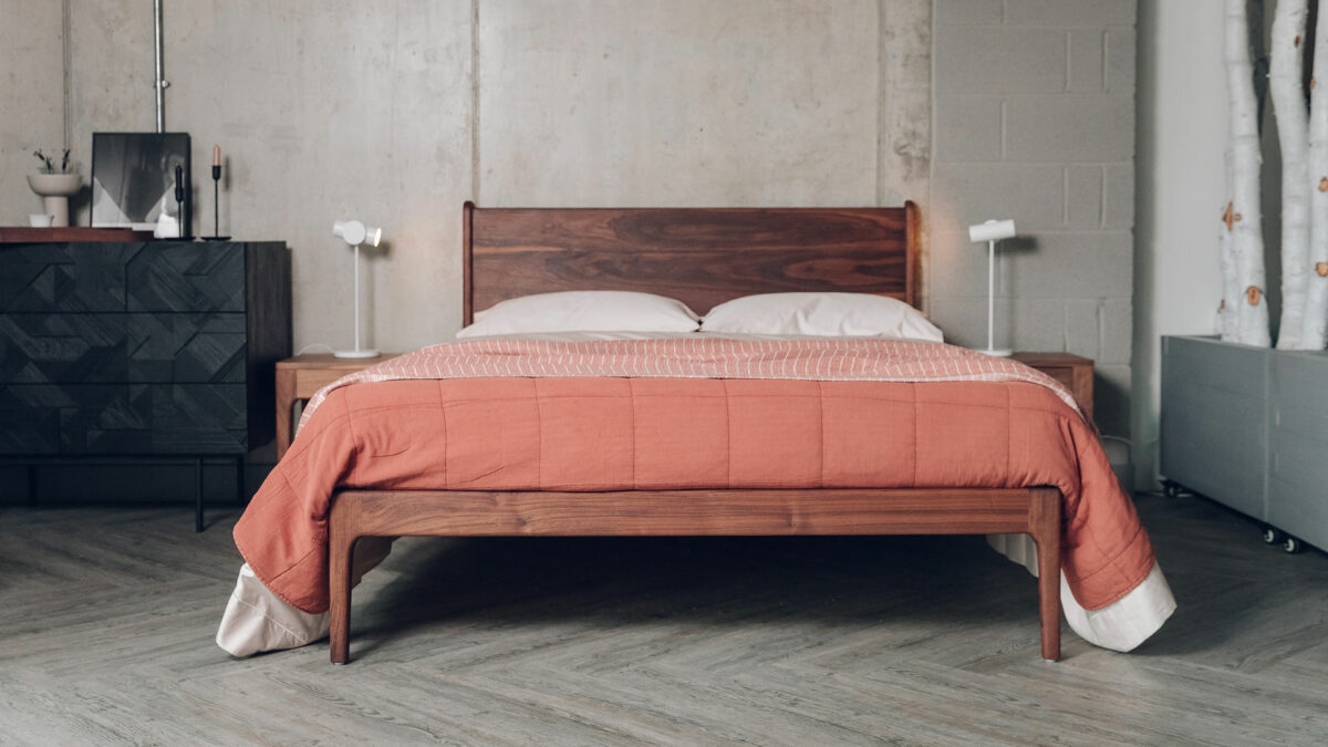 oiled walnut Camden bed with terracotta bedding and black Ethnicraft chest
