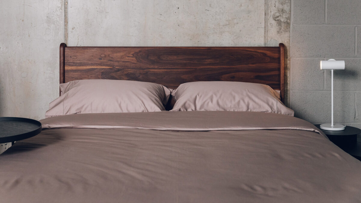 taupe sateen bedding on a walnut wood Camden bed with a rich oiled finish