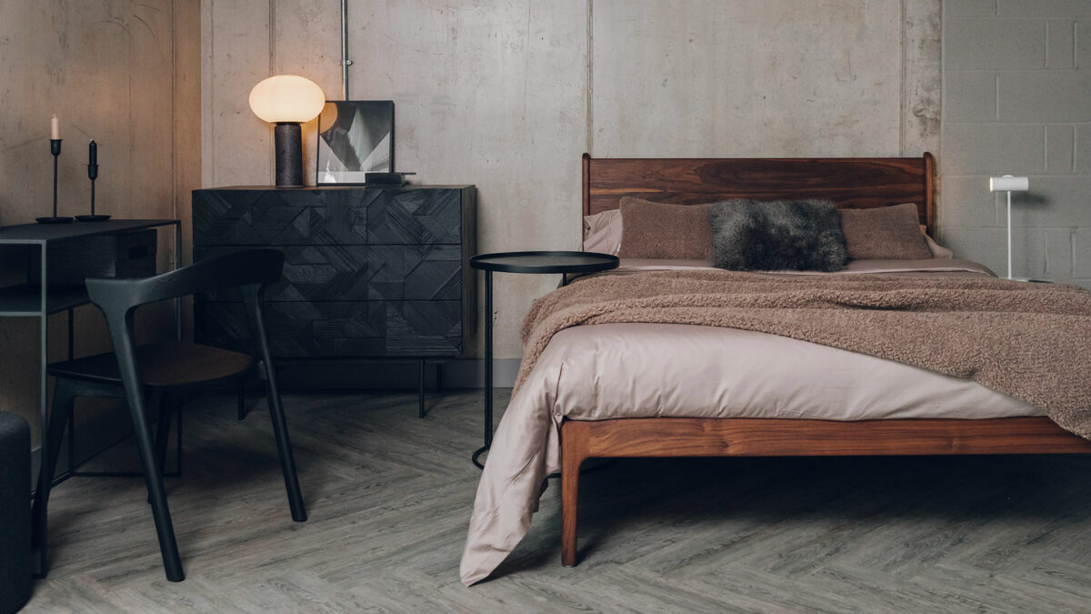 oiled walnut camden bed with black chest of drawers and bok chair