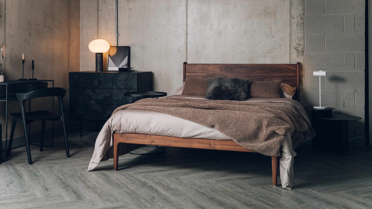 oiled walnut camden bed with taupe bedding and balck furniture