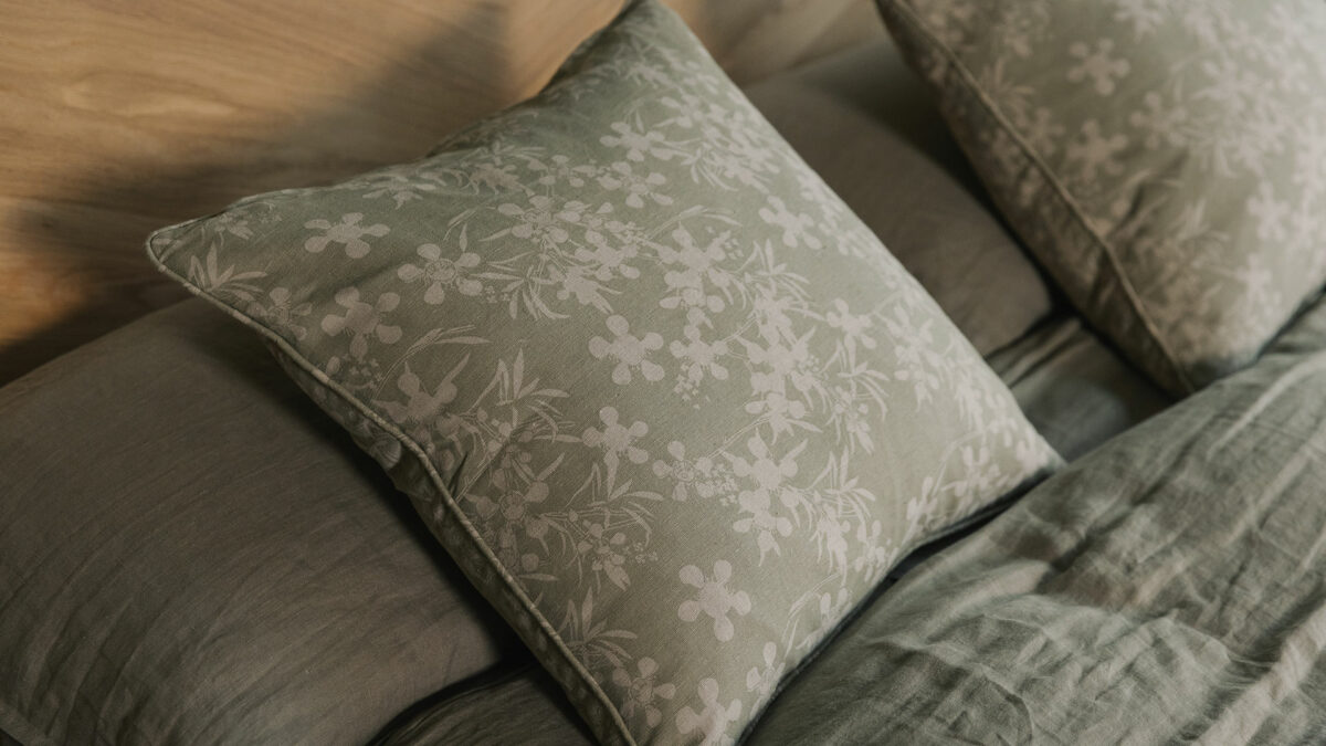 olive green square cushion with beige floral print