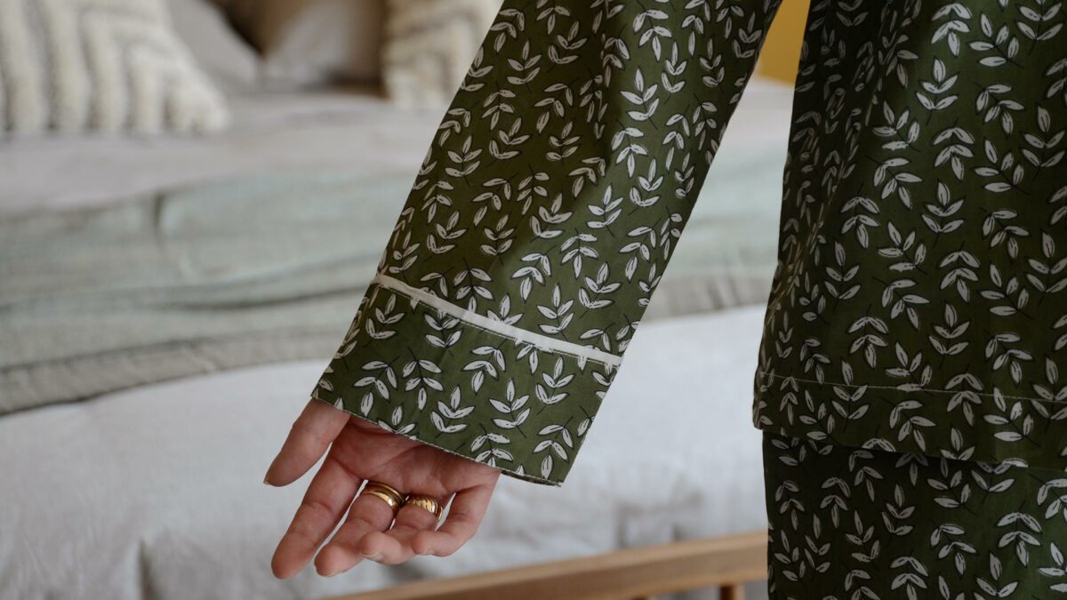 lightweight cotton kimono with a block print leaf design in olive green and white and showing a close up of the contrast edging to the cuffs