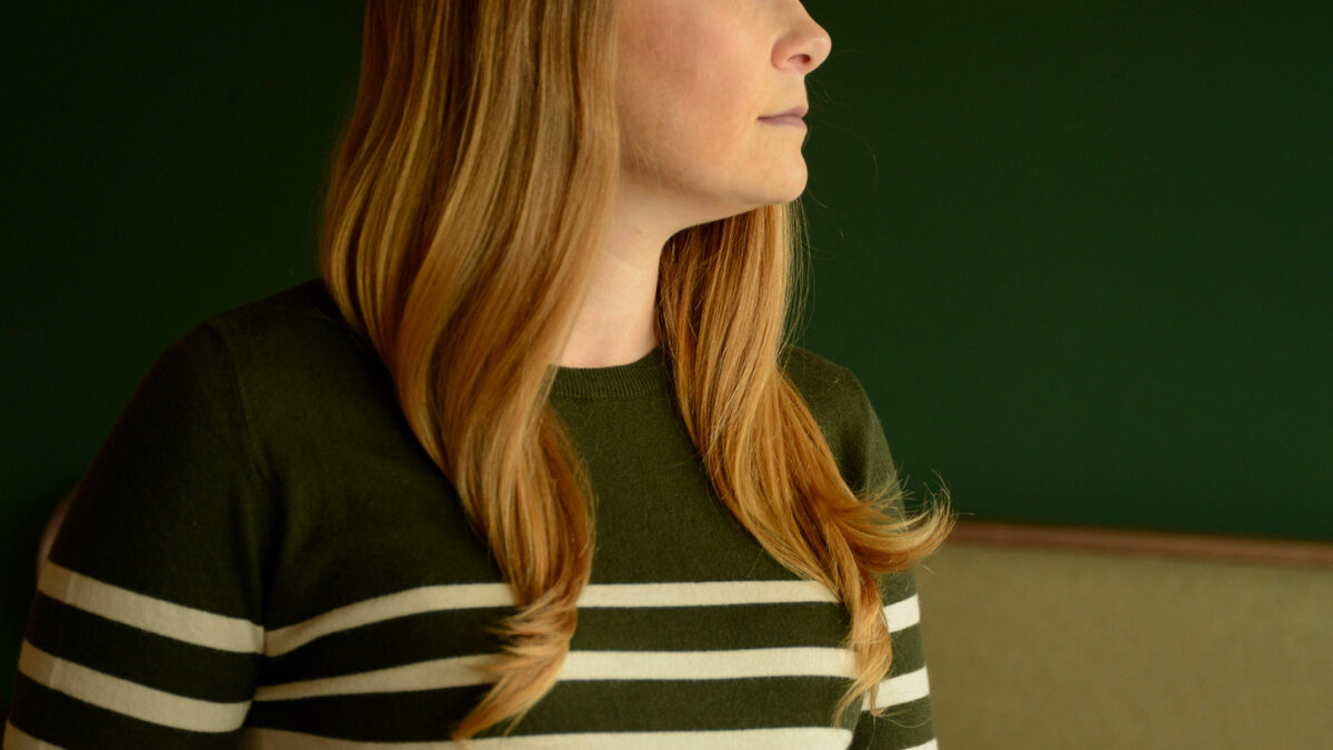 olive green jumper with round neck and ivory stripes