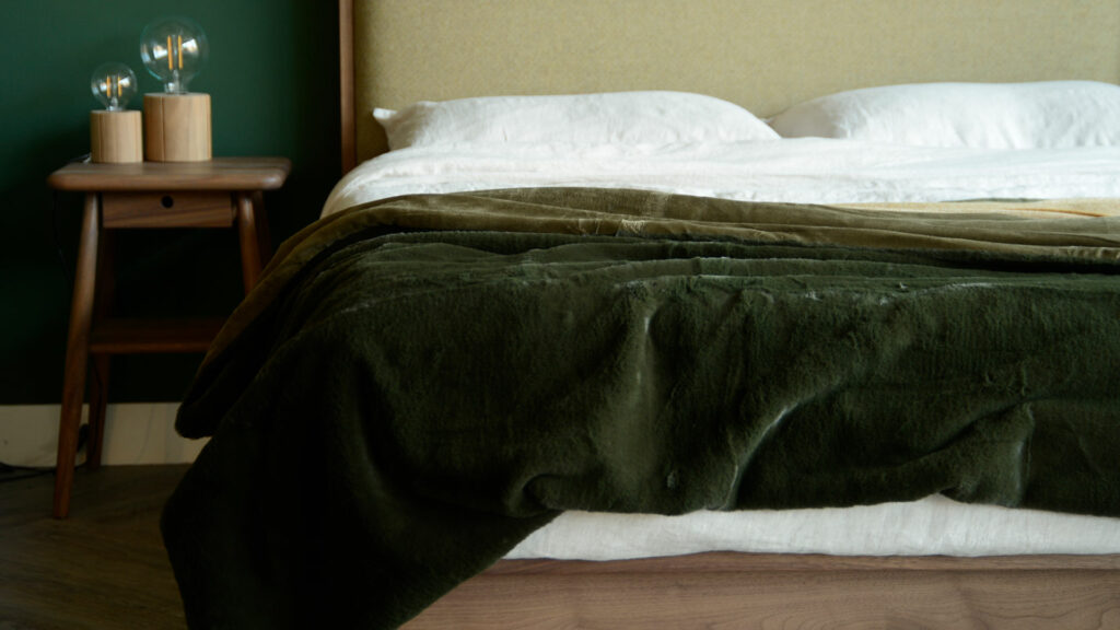 softest luxury faux fur throw in deep olive green autumnal bedroom look