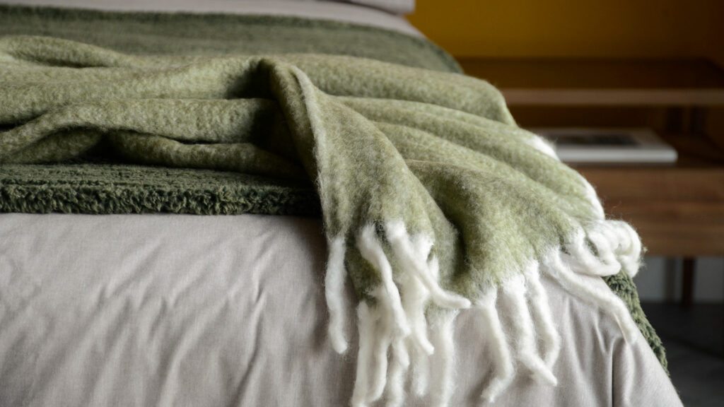 wool blend cosy olive green colour throw with chunky white fringes