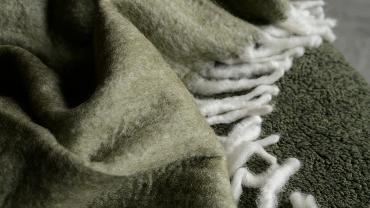 wool blend cosy olive green colour throw with chunky white fringes