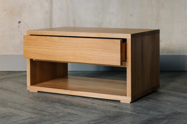 low bedside table with drawer and open shelf and made from solid oak