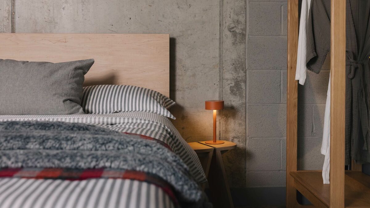 orange bedside lamp with modern Bamford bed in maple wood