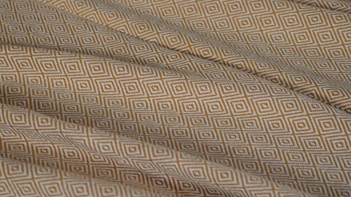 Diamond weave cotton blanket in tan and cream shown close up