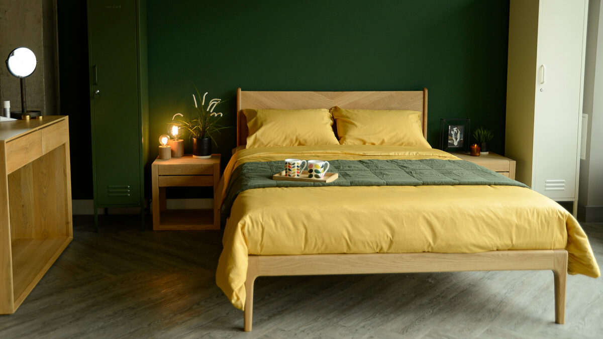 colourful bedrooms forest green wall and mustard yellow bamboo fibre bedding