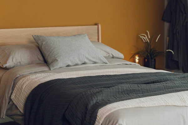 textured certified organic cotton blankets shown on a kingsize bed