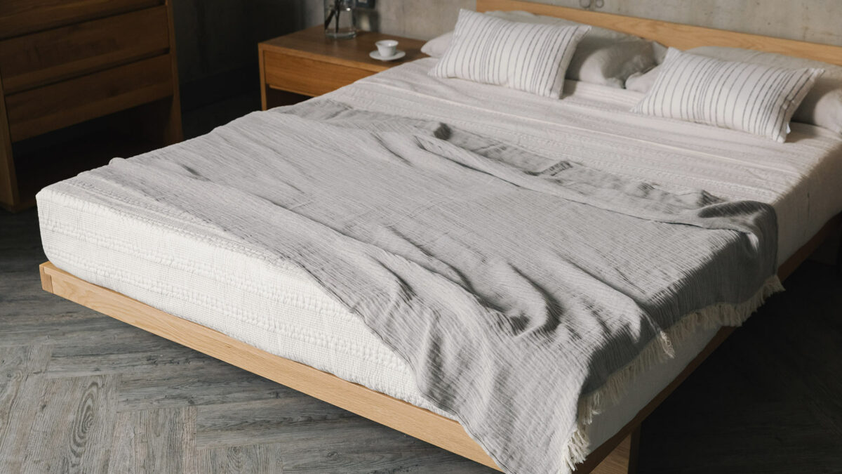 organic cotton linen throw in grey on oak kumo bed