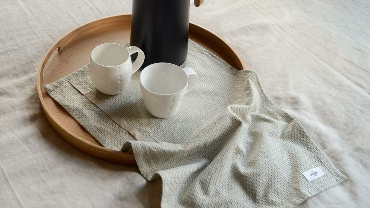 organic cotton little towel on tray with cups
