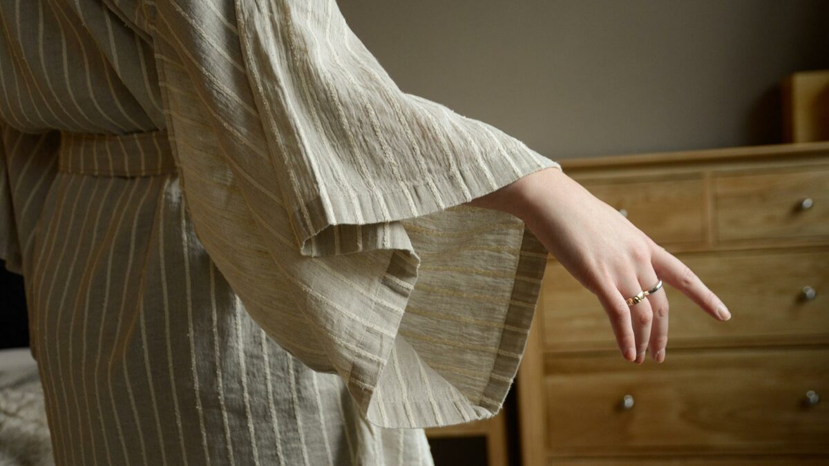 organic linen kimono robe in beige with a textured ivory stripe close up of the sleeves