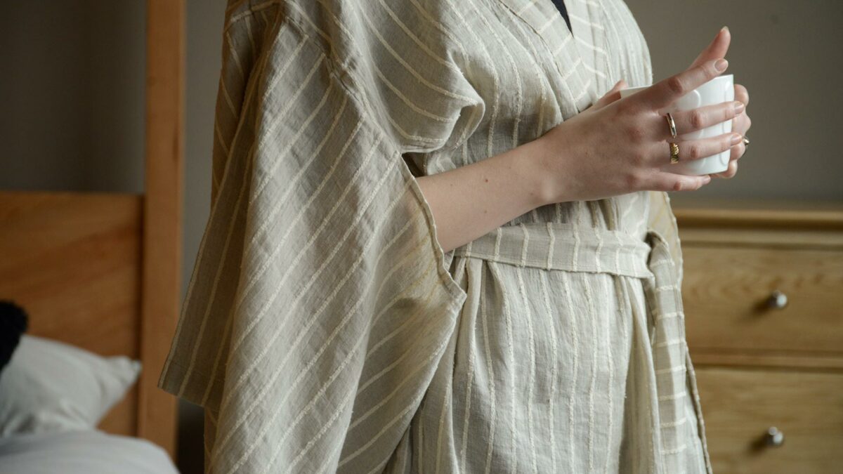 organic linen kimono robe in beige with a textured ivory stripe close up of the sleeves