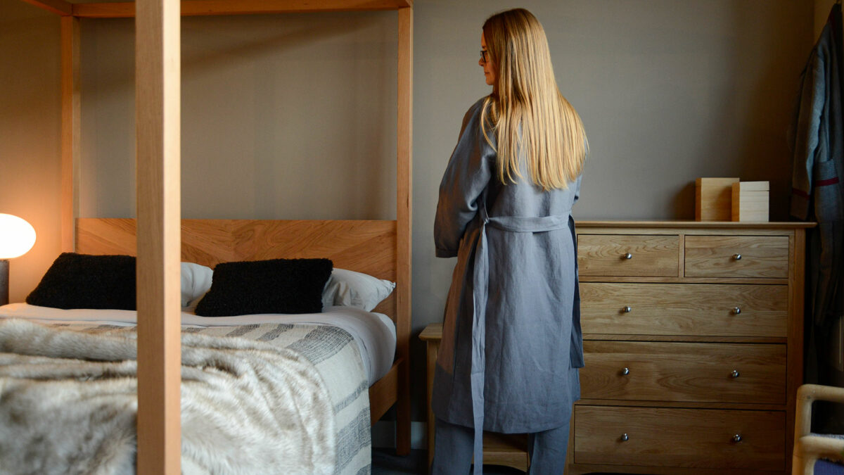 organic linen dressing gown in charcoal grey shown on a model and from the back