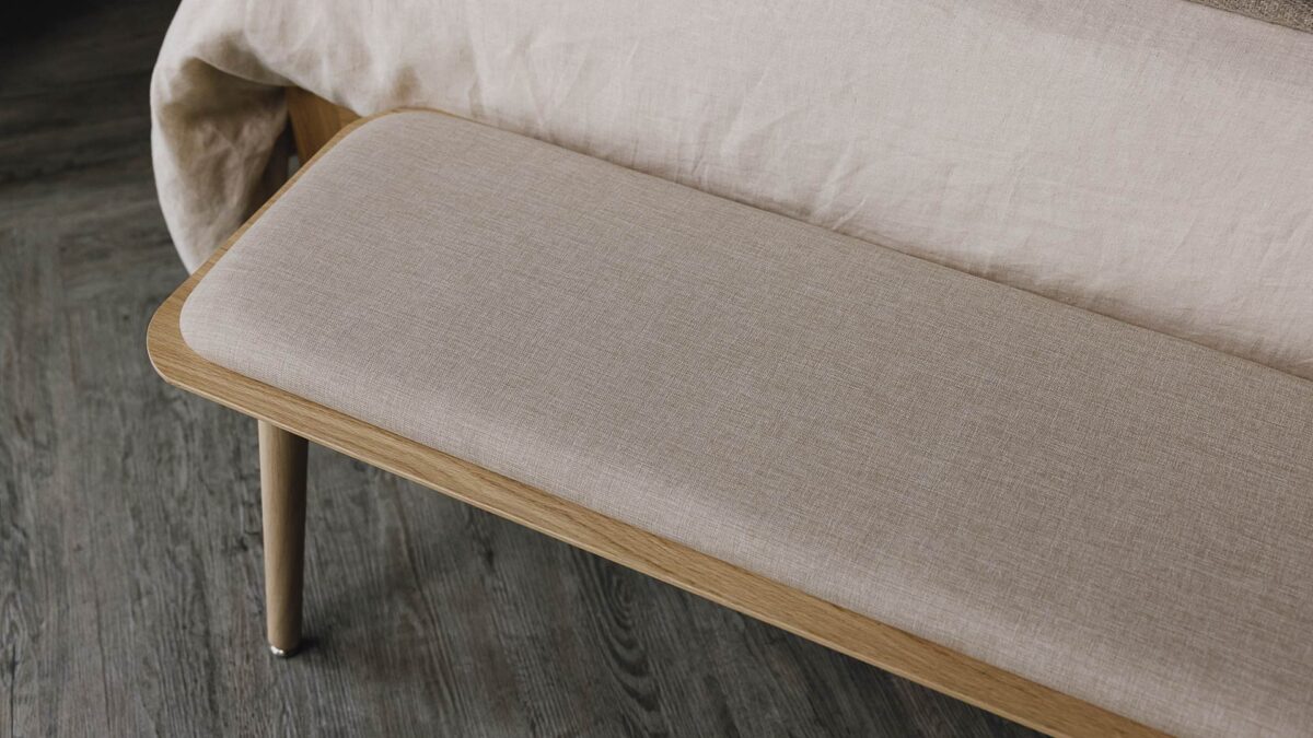 image looking down on padded top of an oak bench.