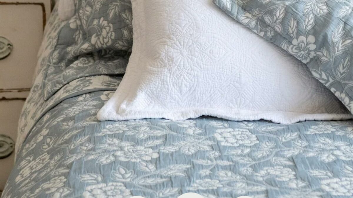 Wedgwood blue and ivory floral patterned reversible quilted bedspread