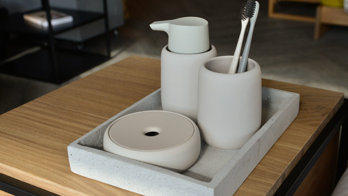 soft touch bathroom accessories in pale clay colour including soap dispenser and storage jar