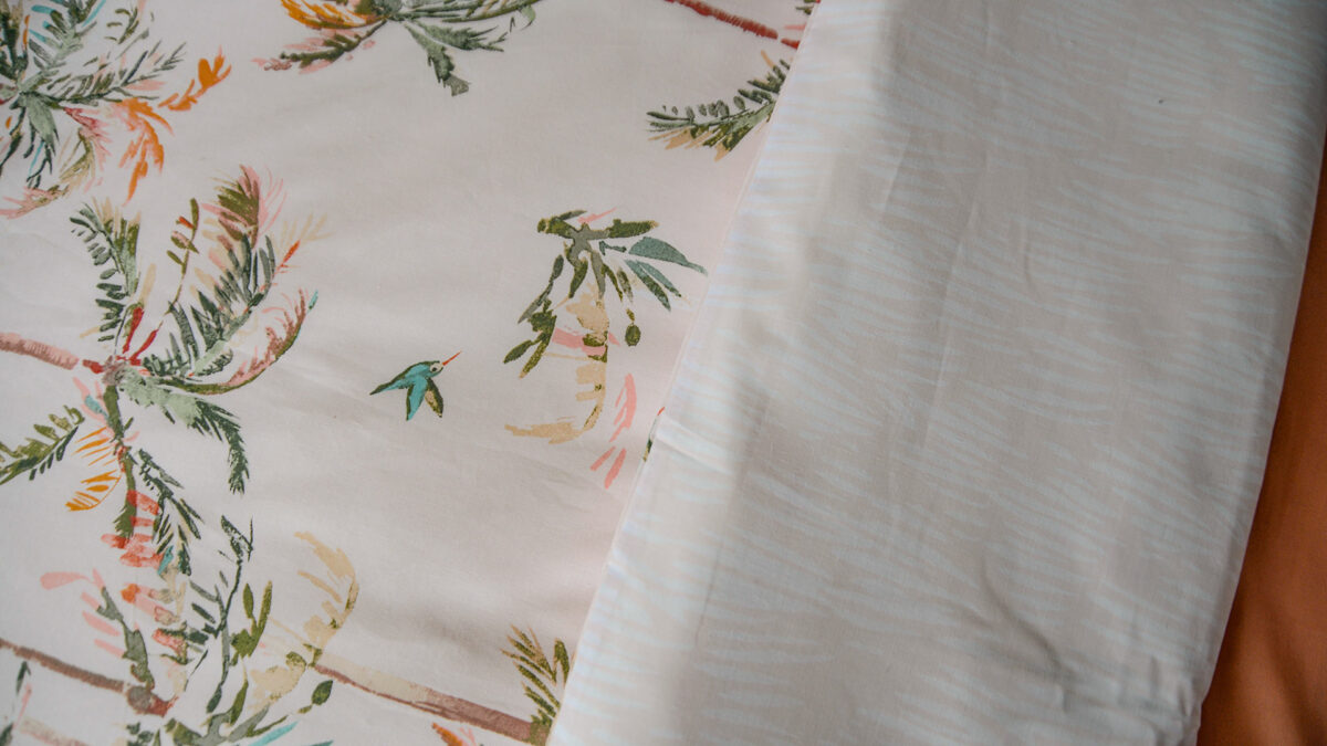 reversible blush pink duvet cover set with tropical palms print a closer view