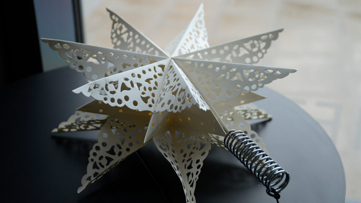 paper star Xmas tree topper decoration with cut-out lace patterns