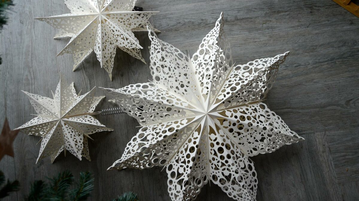 paper fold out star decorations with cut-out lace patterns