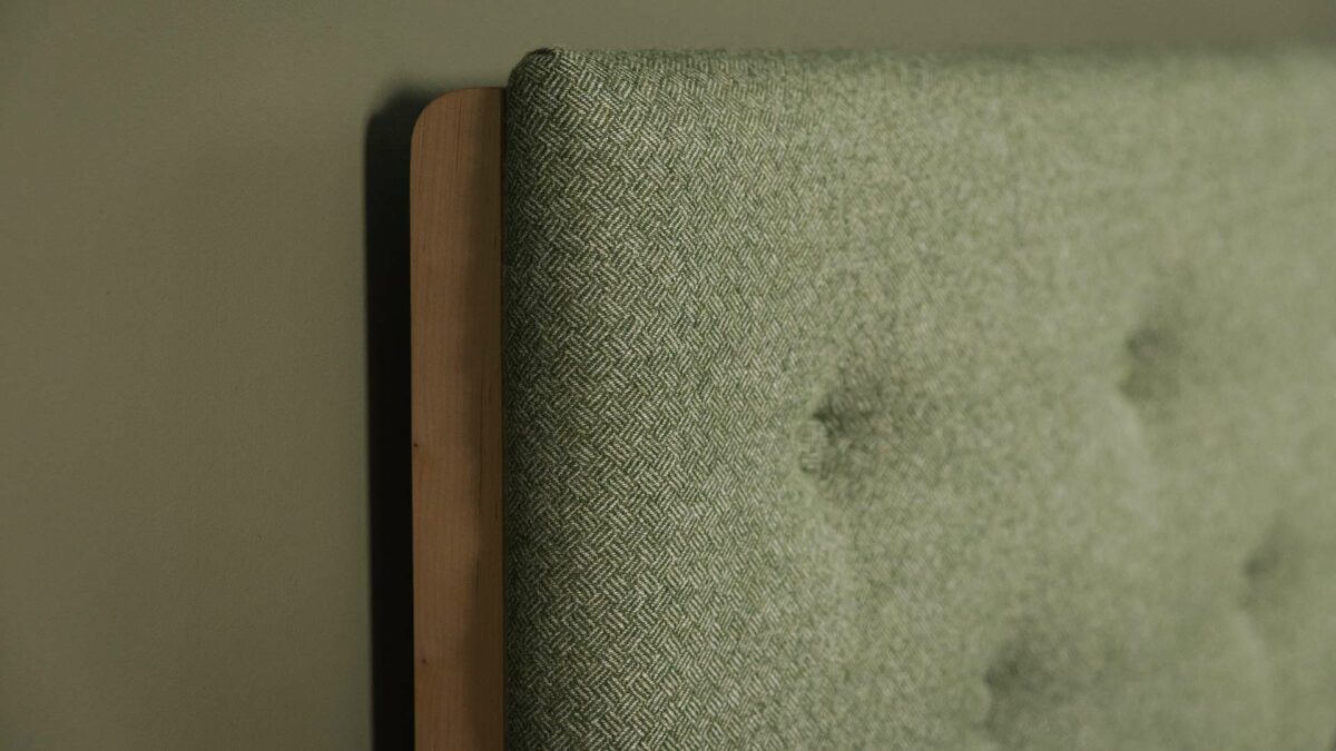 close up of the Parquet upholstered headboard in green