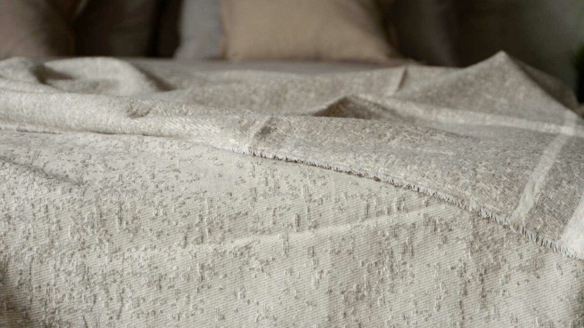 cotton rich textured bedspread in ecru and ivory shown close up