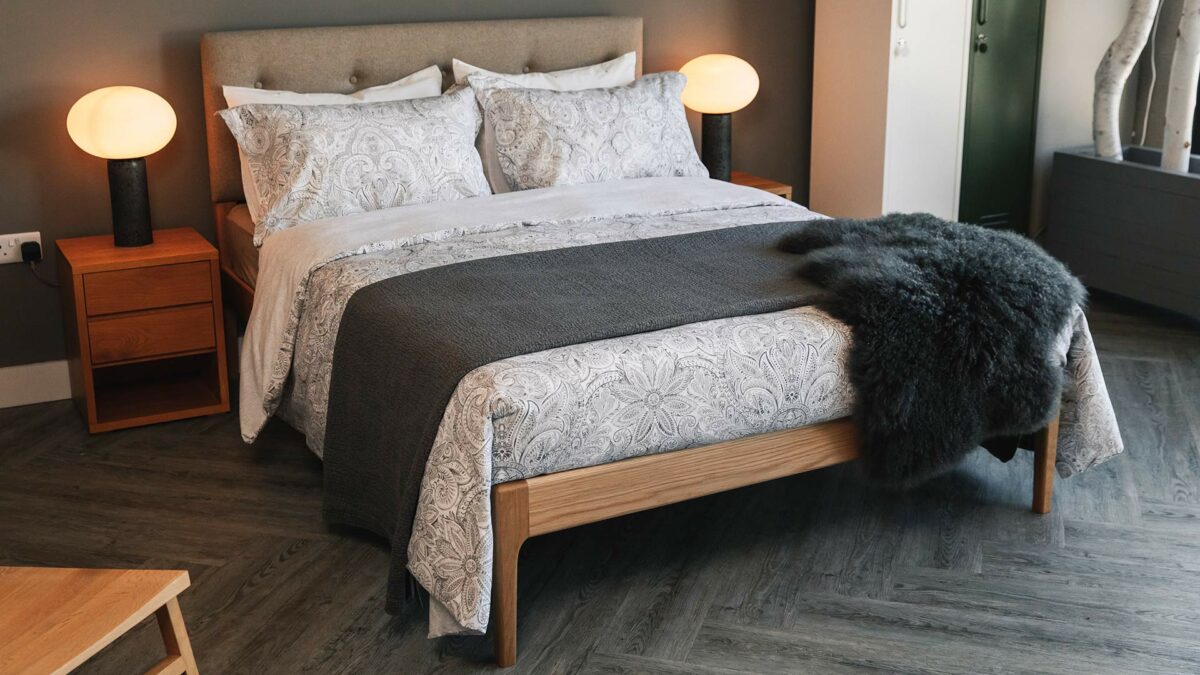 crisp white and grey print duvet set shown with a dark grey bedspread