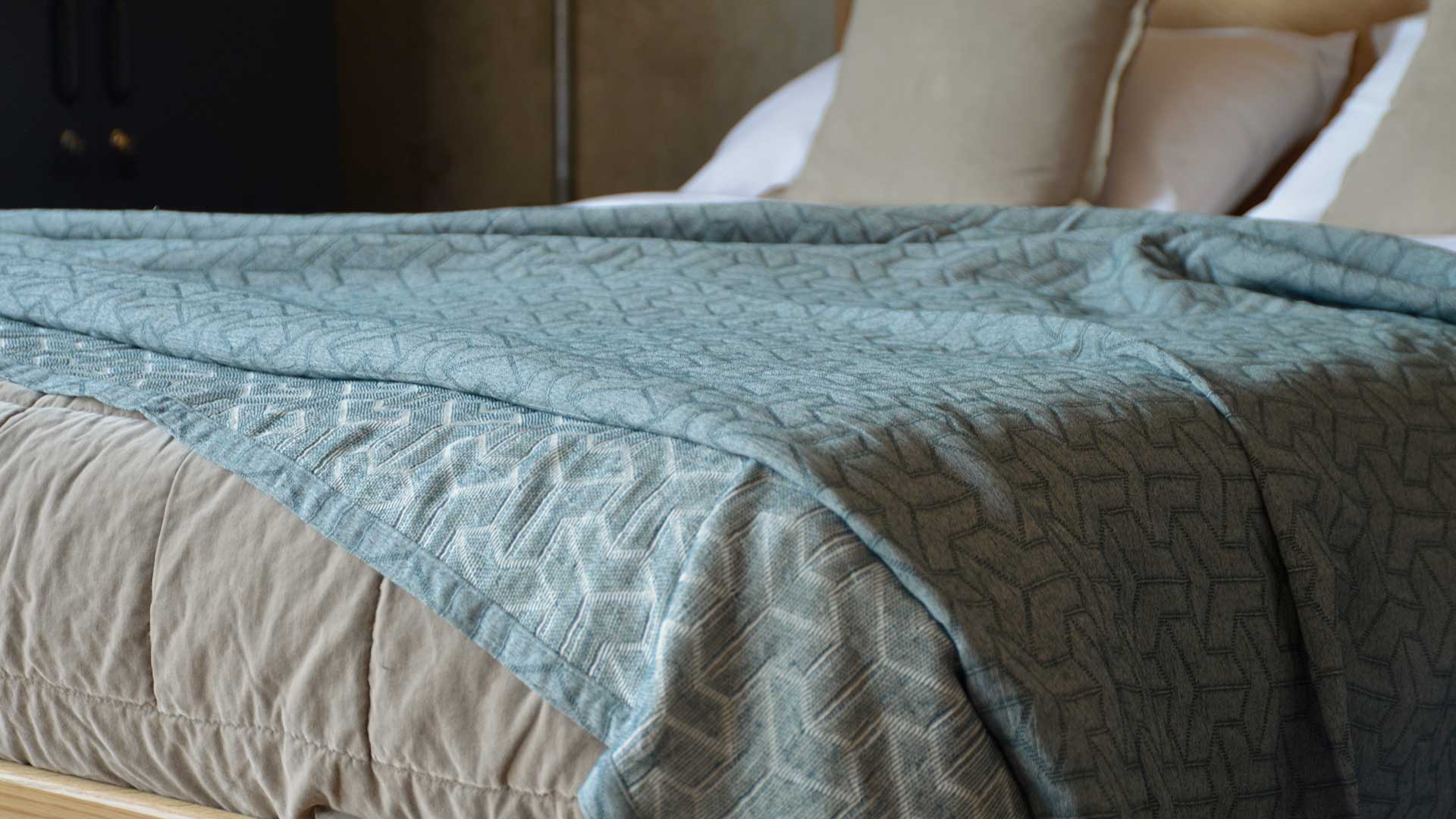 petrol blue recycled cotton bedspread with stitched geometric pattern