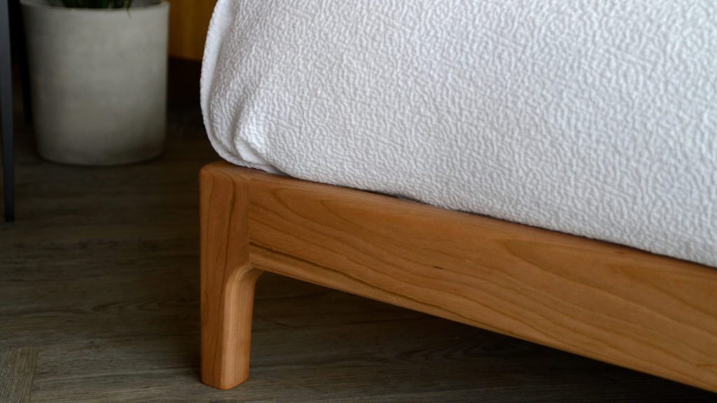 A closer view of the foot of the hand made low Pimlico bed in solid cherry