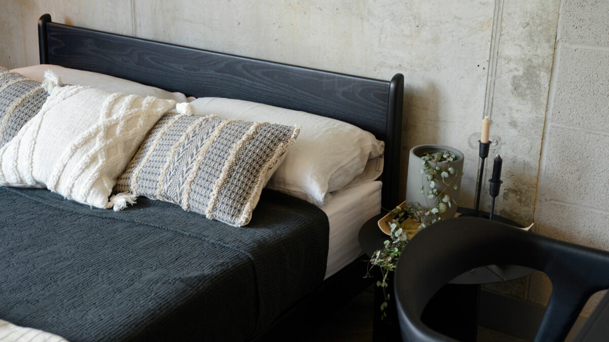 A monochrome bedroom look with Black stained Ash low Pimlico bed and black and ecru bedding