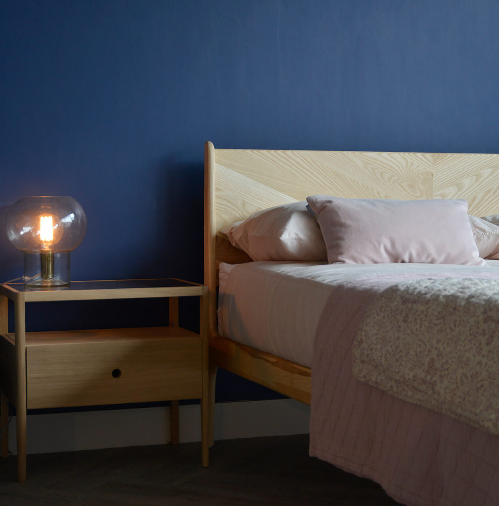 Ash Hoxton contemporary wooden bed shown with an Oak Spindle bedside storage table.