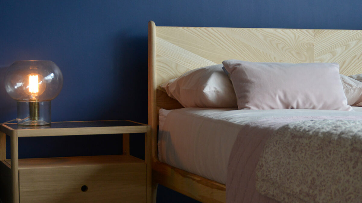 Ash Hoxton contemporary wooden bed shown with an Oak Spindle bedside storage table.