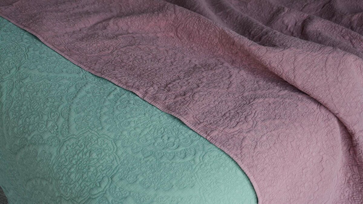 floral embroidered quilted bedspreads in sage green and dusky pink