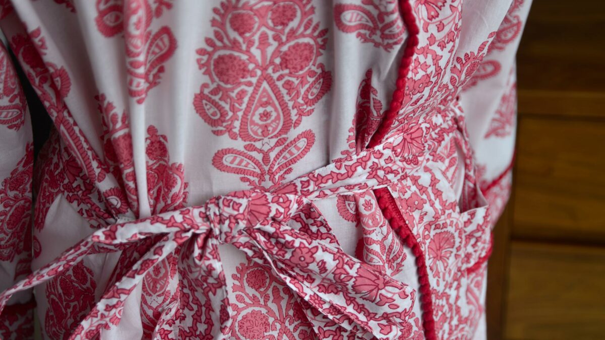 close up of the pink block print pattern of our light cotton dressing gown