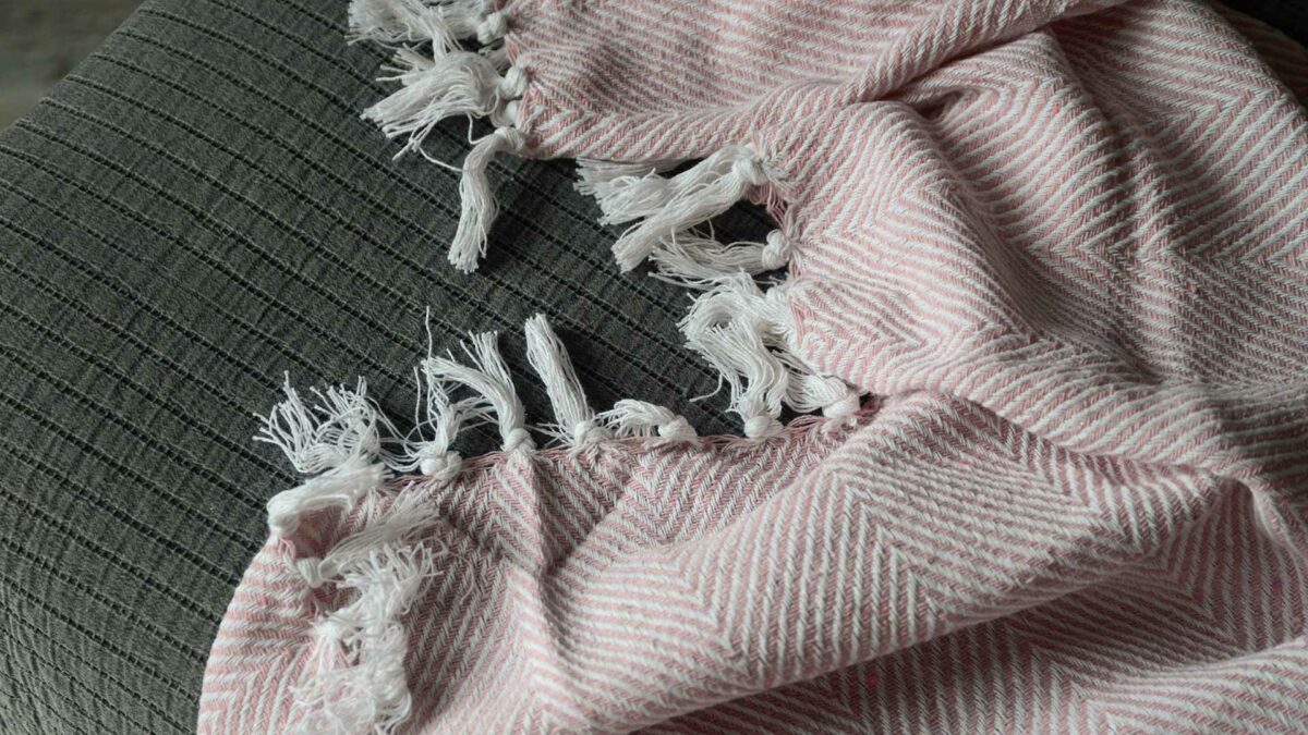 pink chevron patterned throw made with recycled fibres