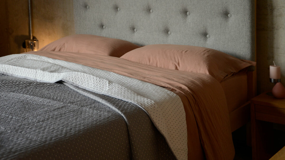 pink clay bedding with reversible grey and ivory quilt