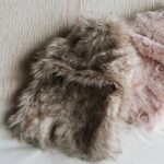 pink coloured faux-fur covered hot water bottles