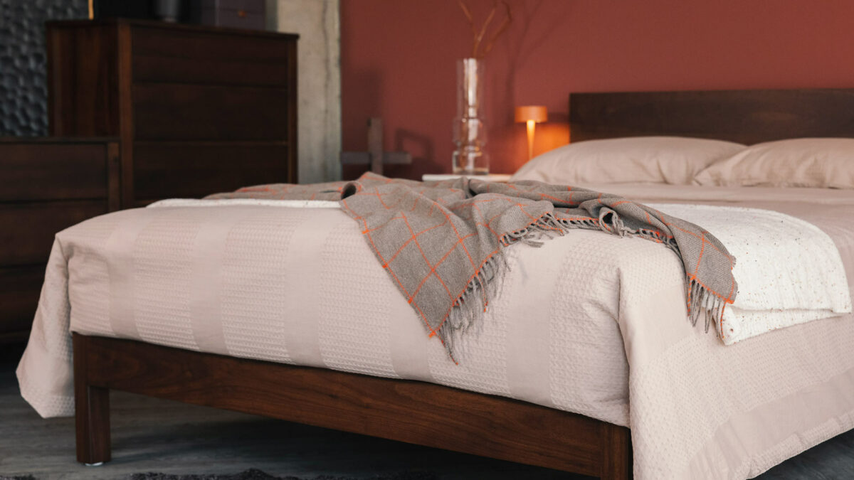 plaster waffle stripe bedding with cashmere throw on smoked walnut bed