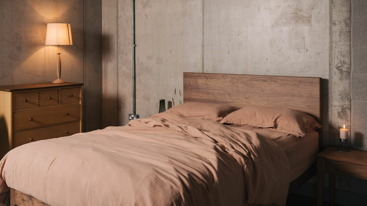 clay pink muslin look bedding shown on a walnut wood kingsize bed