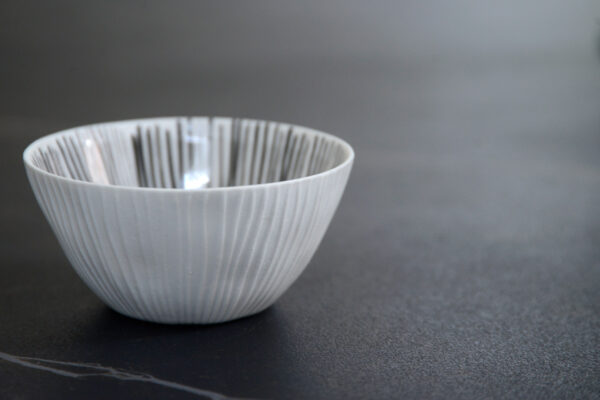 small ribbed porcelain bowl with painted grey stripes to the inside