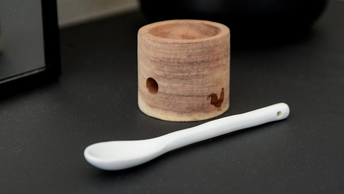 wooden egg cup with porcelain spoon